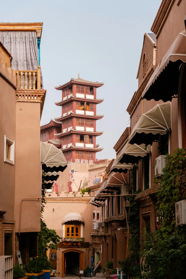 The old city of Kashgar in Xinjiang, with traditional earth-toned buildings and a tiered tower