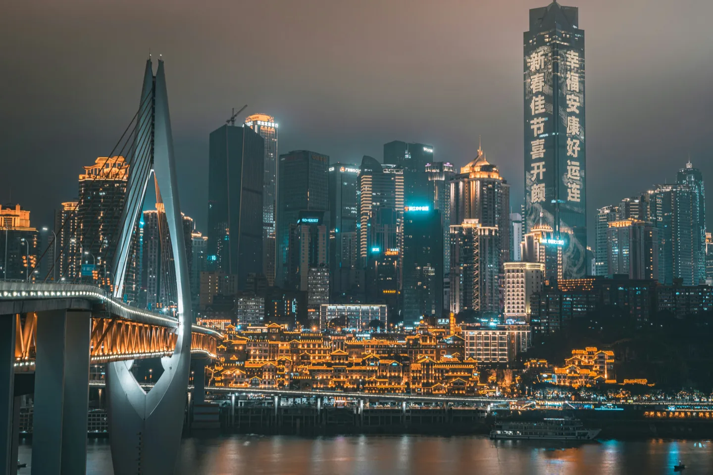 The illuminated Hongya Cave and Qiansimen Bridge in Chongqing at night