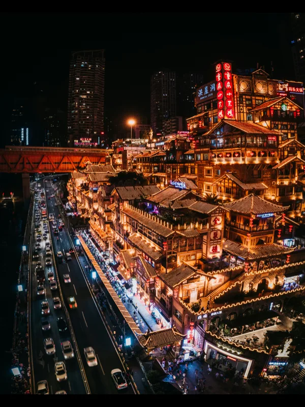 The illuminated stilted houses of Hongya Cave above the river in Chongqing